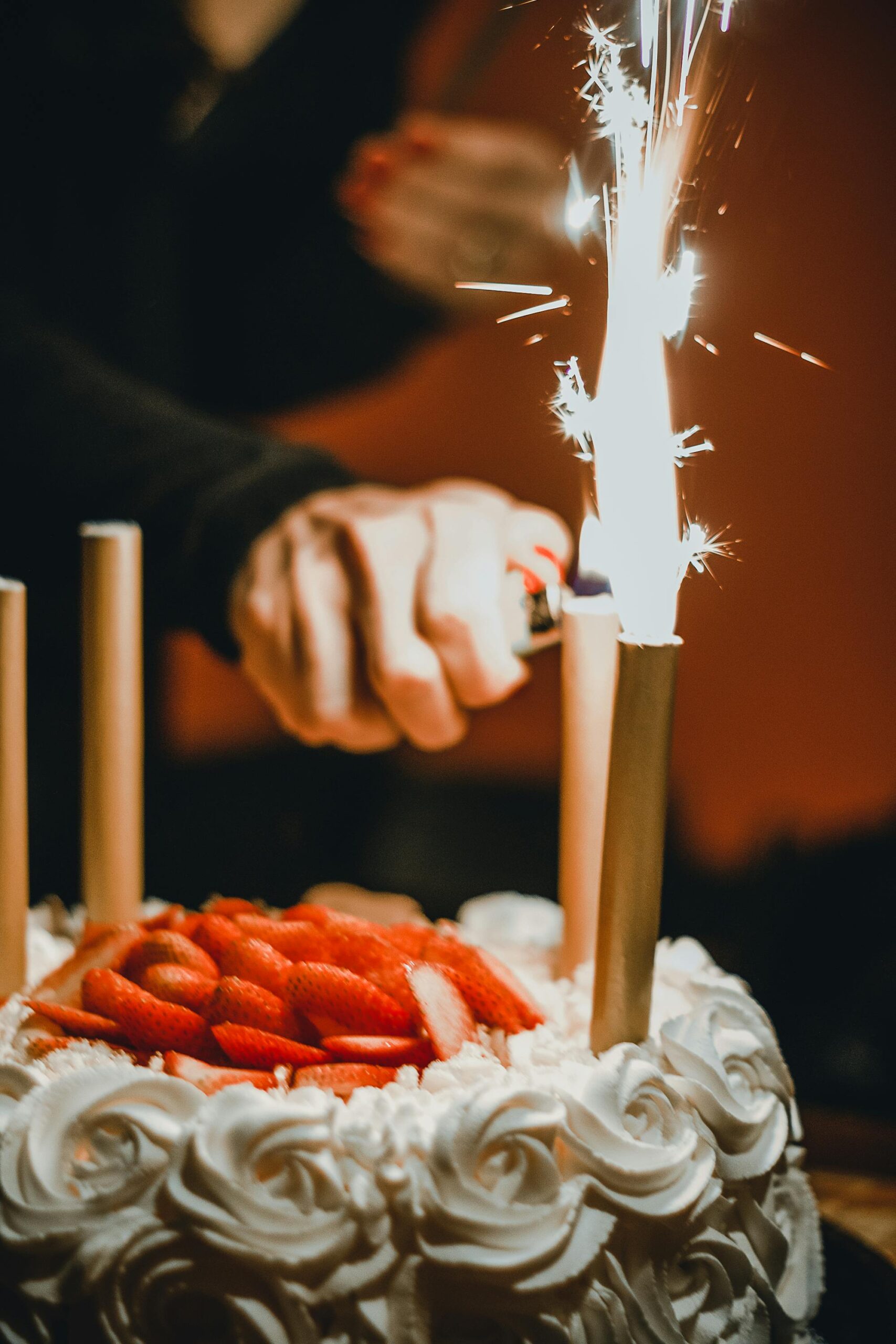 A captivating image of a birthday cake adorned with lit sparklers and fresh strawberries.