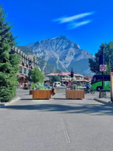 Capture of Banff's bustling main street with a stunning backdrop of the Canadian Rockies.